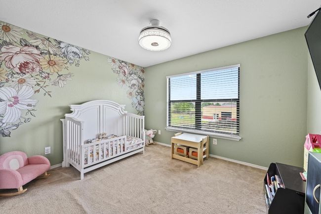 Carpeted bedroom featuring a crib and​​‌​​​​‌​​‌‌​‌‌​​​‌‌​​‌‌​‌​​​​​‌ baseboards | Image 27