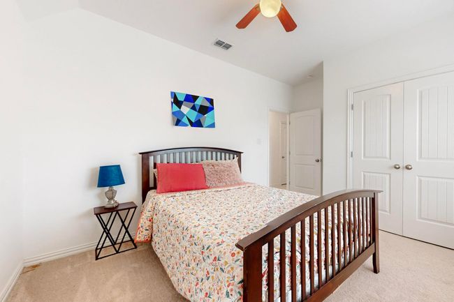 Carpeted bedroom featuring visible vents, a closet, baseboards, and ceiling fan | Image 31