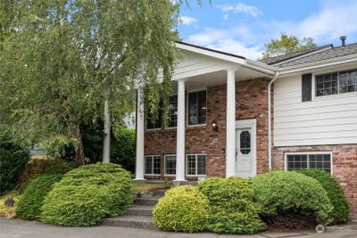 Large pillars and brick facade decorate this classic style home beautifully. Vinyl siding allows for easy maintenance. A brand new roof was installed in March of 2024. | Image 1