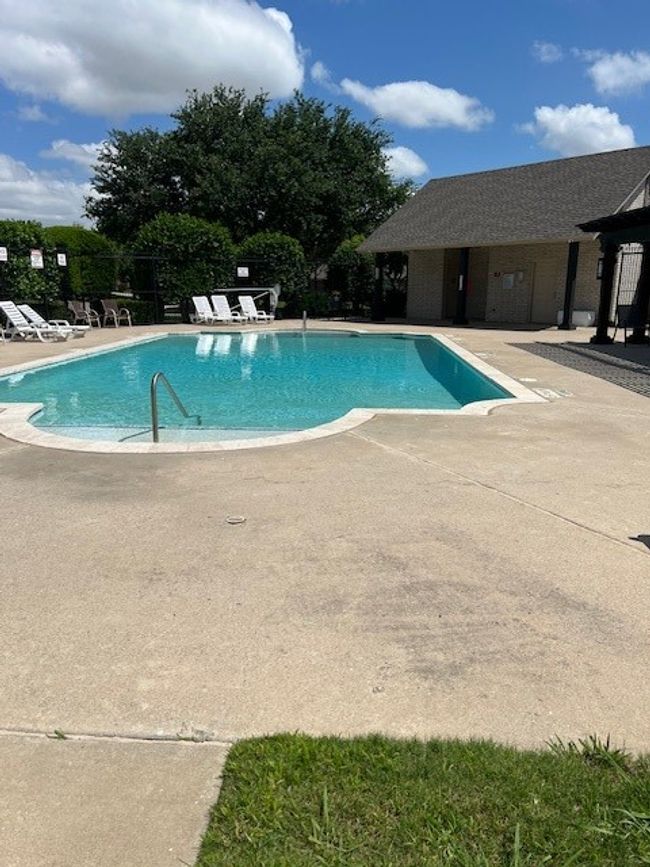 Community pool with a patio and fence | Image 40