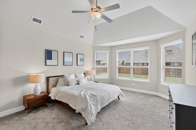 Bedroom with light carpet, lofted ceiling, and ceiling fan | Image 16