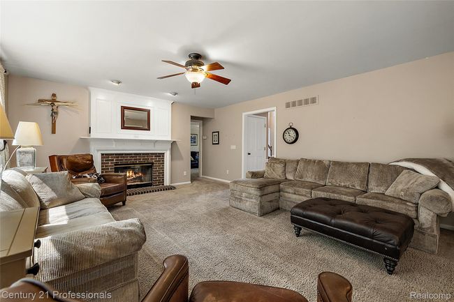 Spacious living area with gas fireplace | Image 11