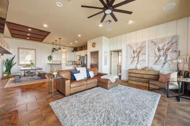 Living room with recessed lighting, dark tile patterned flooring, ceiling fan, and visible vents | Image 7