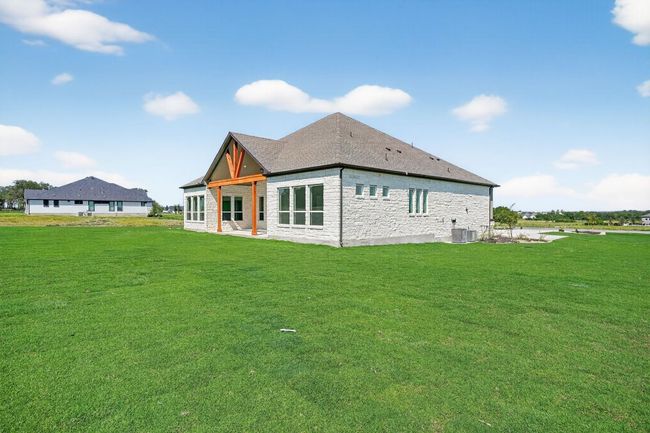 Back of property featuring a patio, a lawn, and stone siding | Image 29