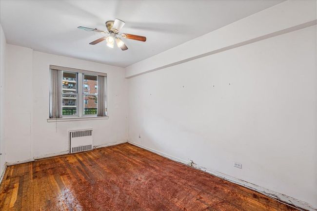 Empty room with radiator and a ceiling fan | Image 11