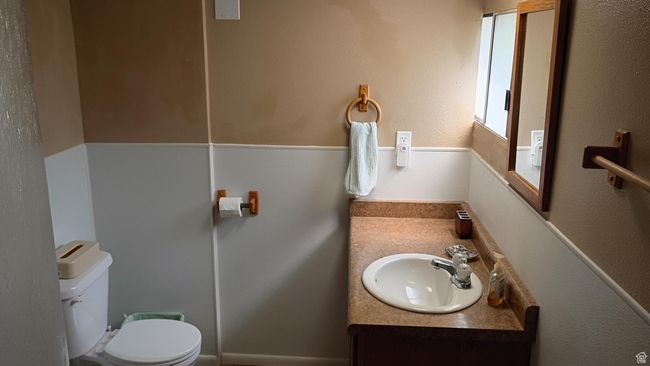 Bathroom featuring a textured wall and vanity | Image 46