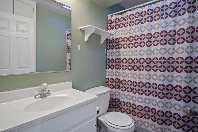 Bathroom featuring vanity and curtained shower | Image 20