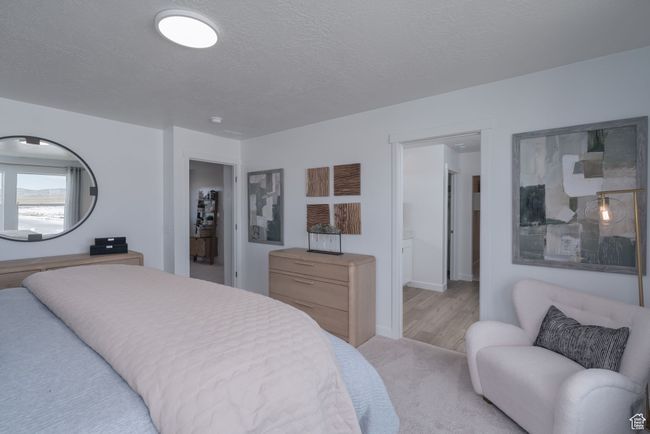 Bedroom with a textured ceiling and light carpet | Image 35