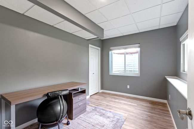 6th Bedroom in the basement is currently being used as an office. It has a large closet as well. | Image 56