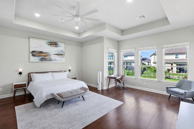 Bedroom with a tray ceiling, wood floors, recessed lighting, and ceiling fan | Image 18