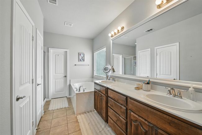 Full bathroom with double vanity, a garden tub, tile patterned flooring, and an enclosed shower | Image 31