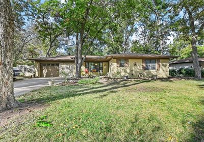 Single story home with a front lawn and a garage | Image 1