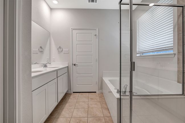 Bathroom featuring double vanity, a garden tub, and tile patterned floors | Image 21