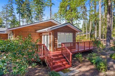 The porch wraps around the side and back of the house. This view looks back towards the dining room. | Image 3