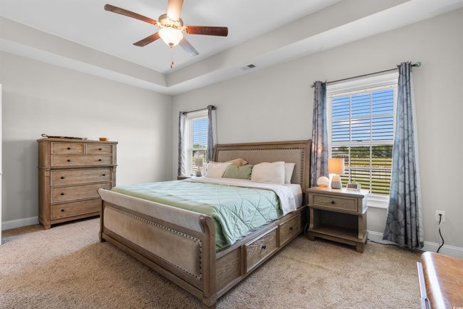 Bedroom with light carpet and a ceiling fan | Image 17