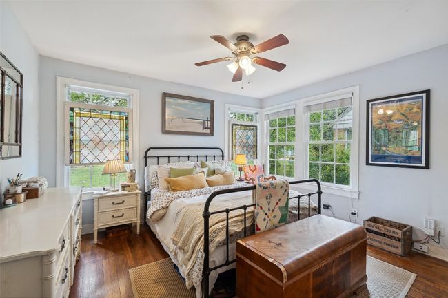 Bedroom #1 with beautiful stained glass windows, real hardwood floors, and tons of natural light | Image 8