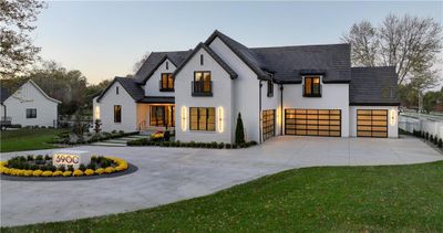 Modern farmhouse style home featuring a lawn and a garage | Image 3