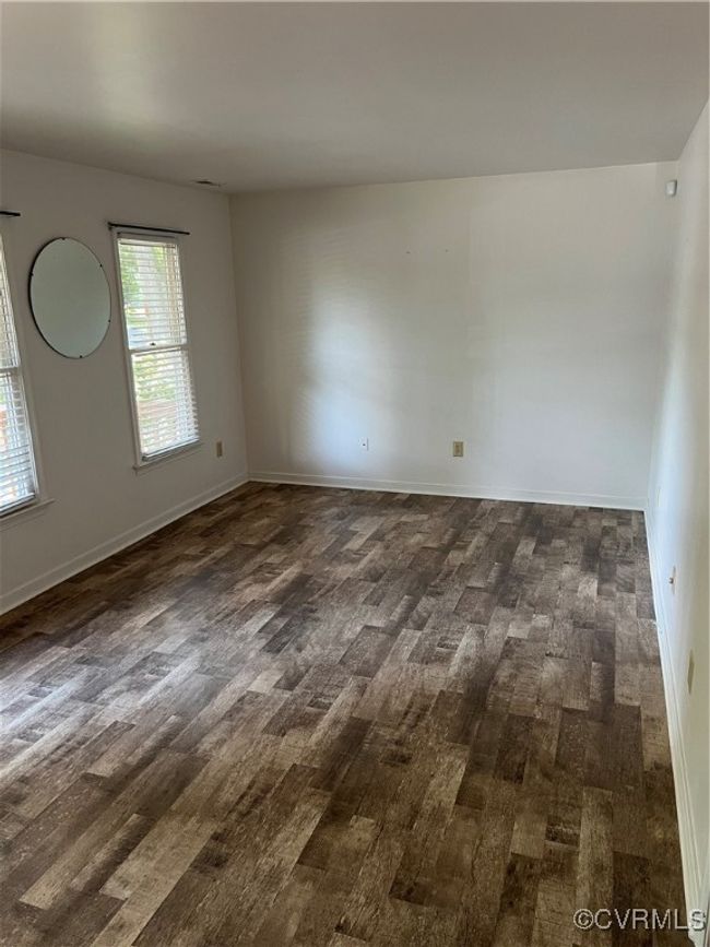Empty room with dark wood-style floors and baseboards | Image 16
