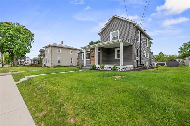 new vinyl siding and the front is highlighted with vinyl shake siding. newer vinyl windows, new glass block windows, new concrete sidewalk, new gutters, downspouts, soffit and fascia! | Image 20