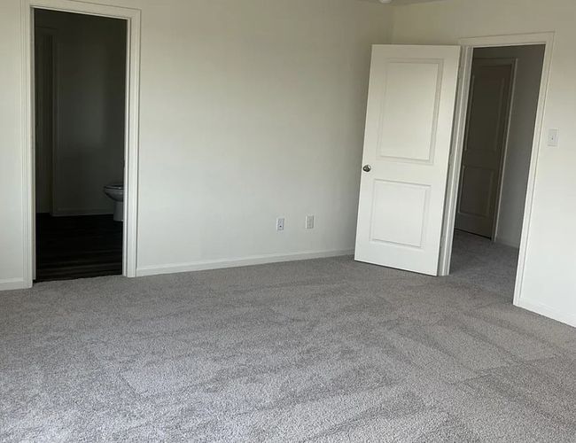 Unfurnished bedroom featuring carpet and ensuite bathroom | Image 7
