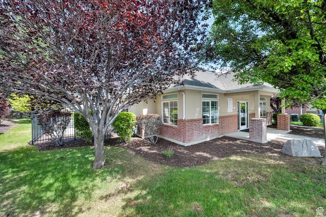 View of front of home featuring stucco siding, brick siding, a front lawn, and roof with shingles | Image 32