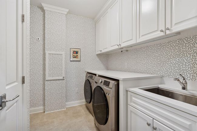 Spacious laundry room with great storage space and sink | Image 24