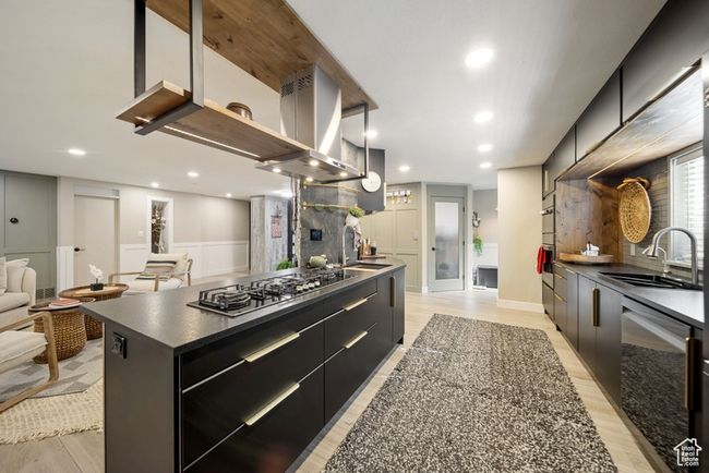 Kitchen with stainless steel appliances, a sink, dark cabinetry, modern cabinets, and recessed lighting | Image 6