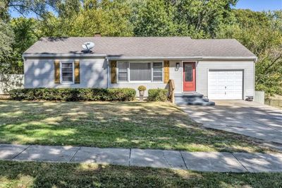 Ranch-style home with a front lawn and a garage | Image 1