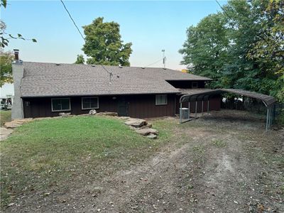 Entrance to lake house with a double carport | Image 1