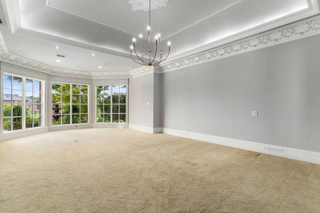 Carpeted spare room with a tray ceiling, a chandelier, and recessed lighting | Image 13