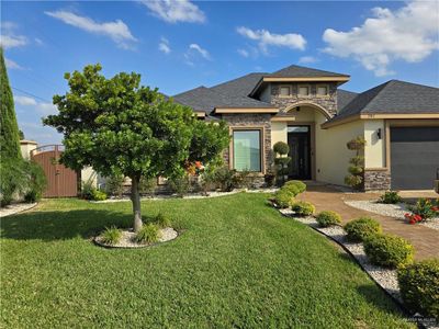 View of front of home with a front lawn and a garage | Image 2