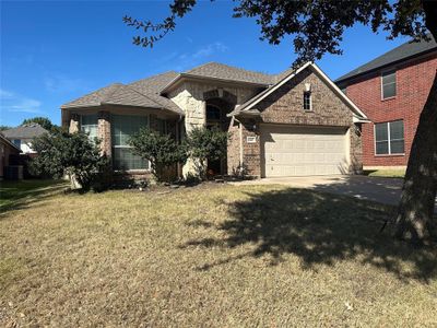 View of front of house featuring a front lawn, central AC unit, and a garage | Image 2