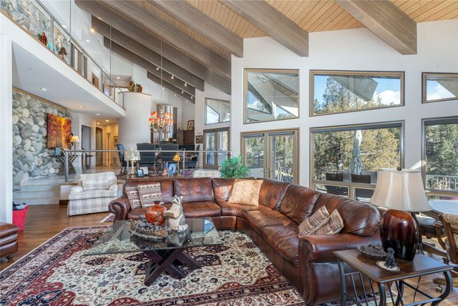 Living room featuring high vaulted ceiling, hardwood / wood-style flooring, and wooden ceiling | Image 12