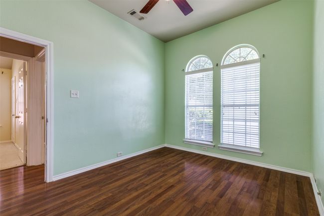 Spare room with dark wood-style flooring and a ceiling fan | Image 17