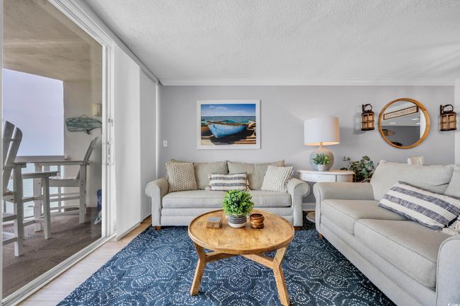 Living room featuring wood finished floors, ornamental molding, and a textured ceiling | Image 13