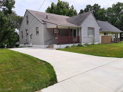 View of front of home with a front lawn and covered porch | Image 1