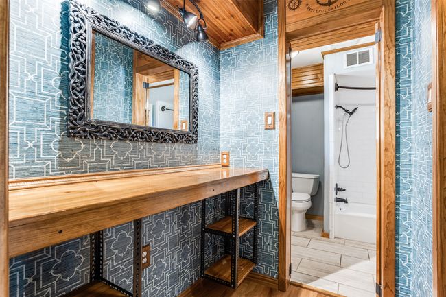 Bathroom with toilet, wood finished floors, and shower / tub combination | Image 31