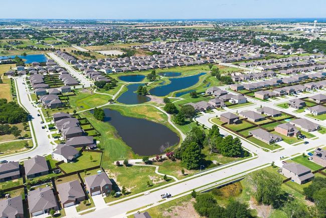 Aerial overview of property's location with a large body of water and nearby suburban area | Image 36
