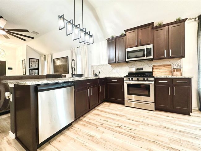 Upgraded floors, upgraded stove, upgraded lighting, upgraded sink! | Image 10