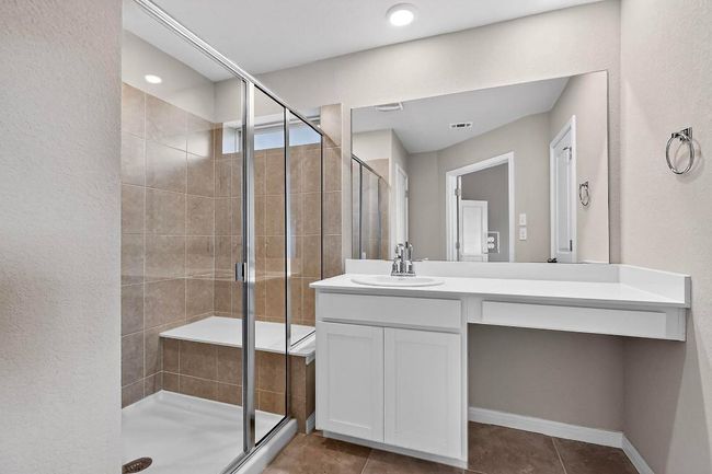 Full bathroom featuring vanity, a shower stall, and tile patterned flooring | Image 23