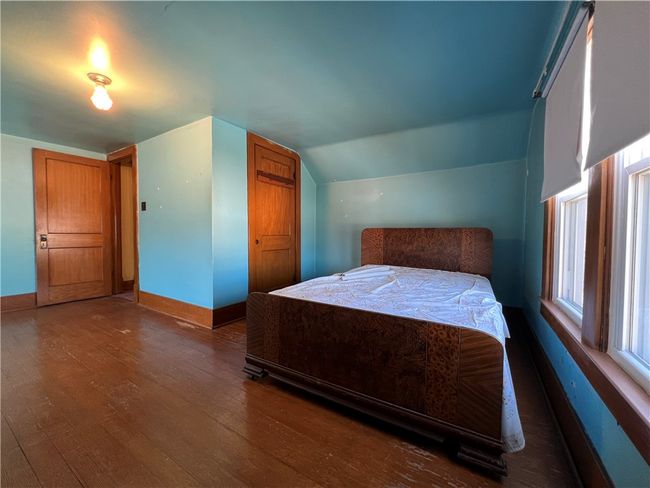 Upper level bedroom with hardwood flooring. | Image 14