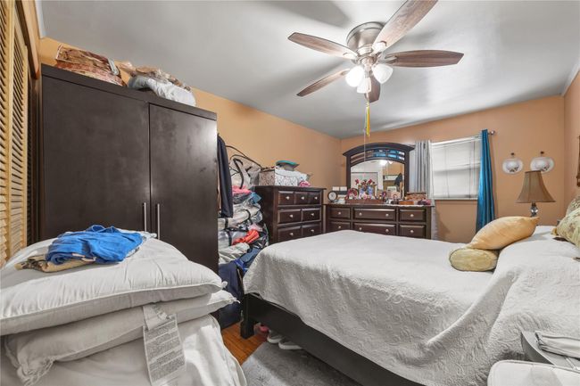 Bedroom with wood finished floors and a ceiling fan | Image 32