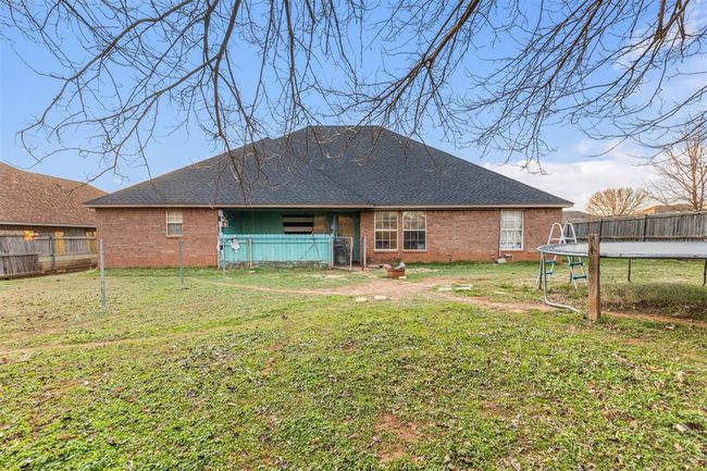 Back of house with a trampoline and a lawn | Image 20