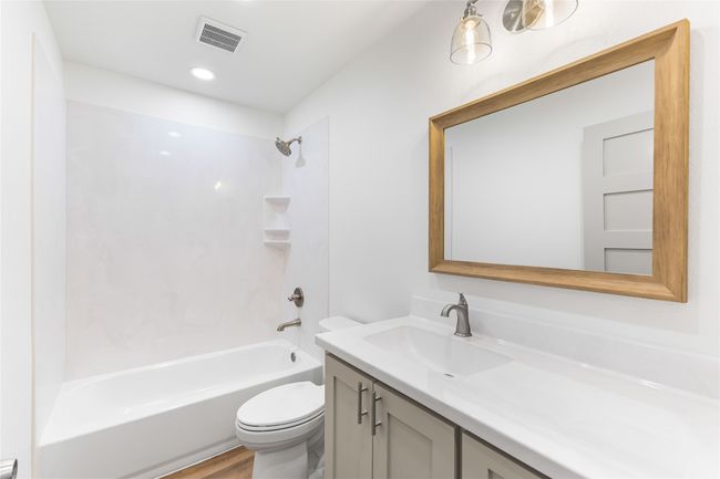 Bathroom with toilet, vanity, shower combination, and wood finished floors | Image 23