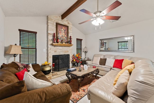 Living area featuring a fireplace and ceiling fan | Image 7