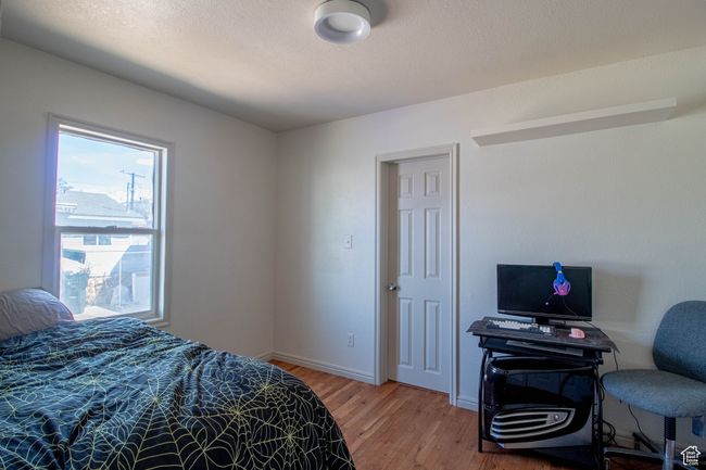Bedroom featuring light wood-type flooring and baseboards | Image 14