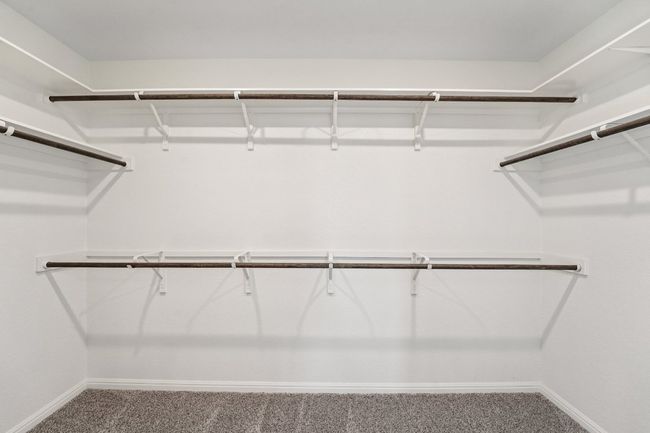 Spacious closet with carpet flooring | Image 14