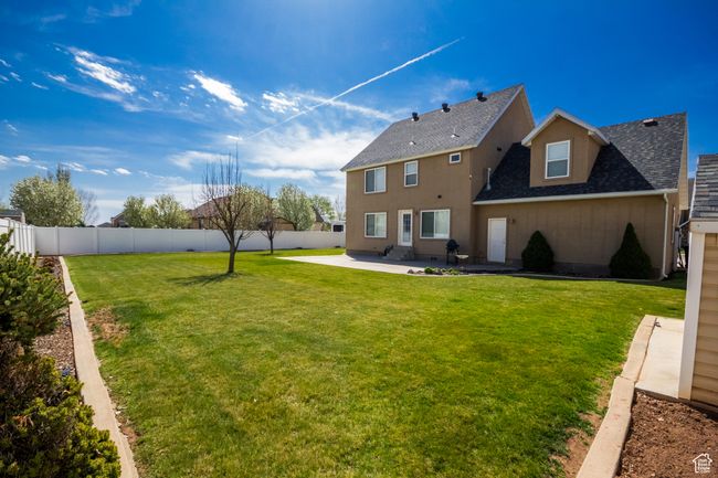 Rear view of house featuring a lawn, roof with shingles, a patio, and a fenced backyard | Image 36