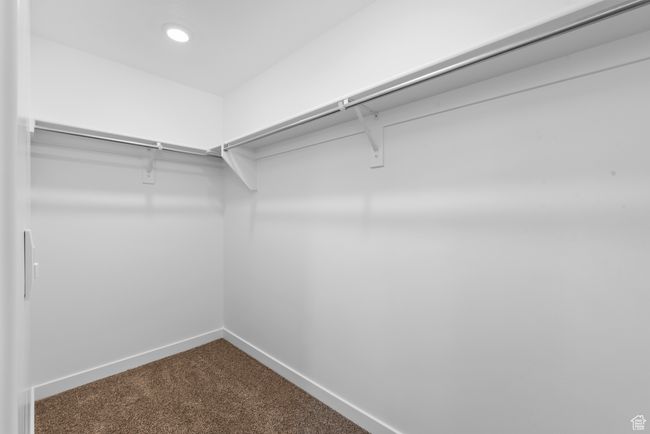 Spacious closet featuring dark carpet | Image 17