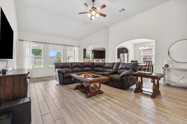 Wall of windows with views of covered patio and backyard; Enjoy the taller ceilings | Image 7